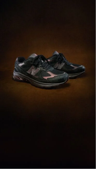 ABZORB 2010 shoes with a dark brown background.