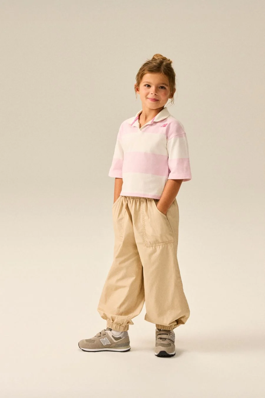 Girl wearing a pair of grey 574 shoes.