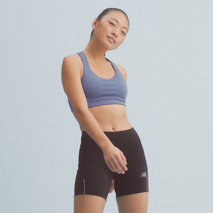 Woman wearing the NB Power X Bra with black bike shorts