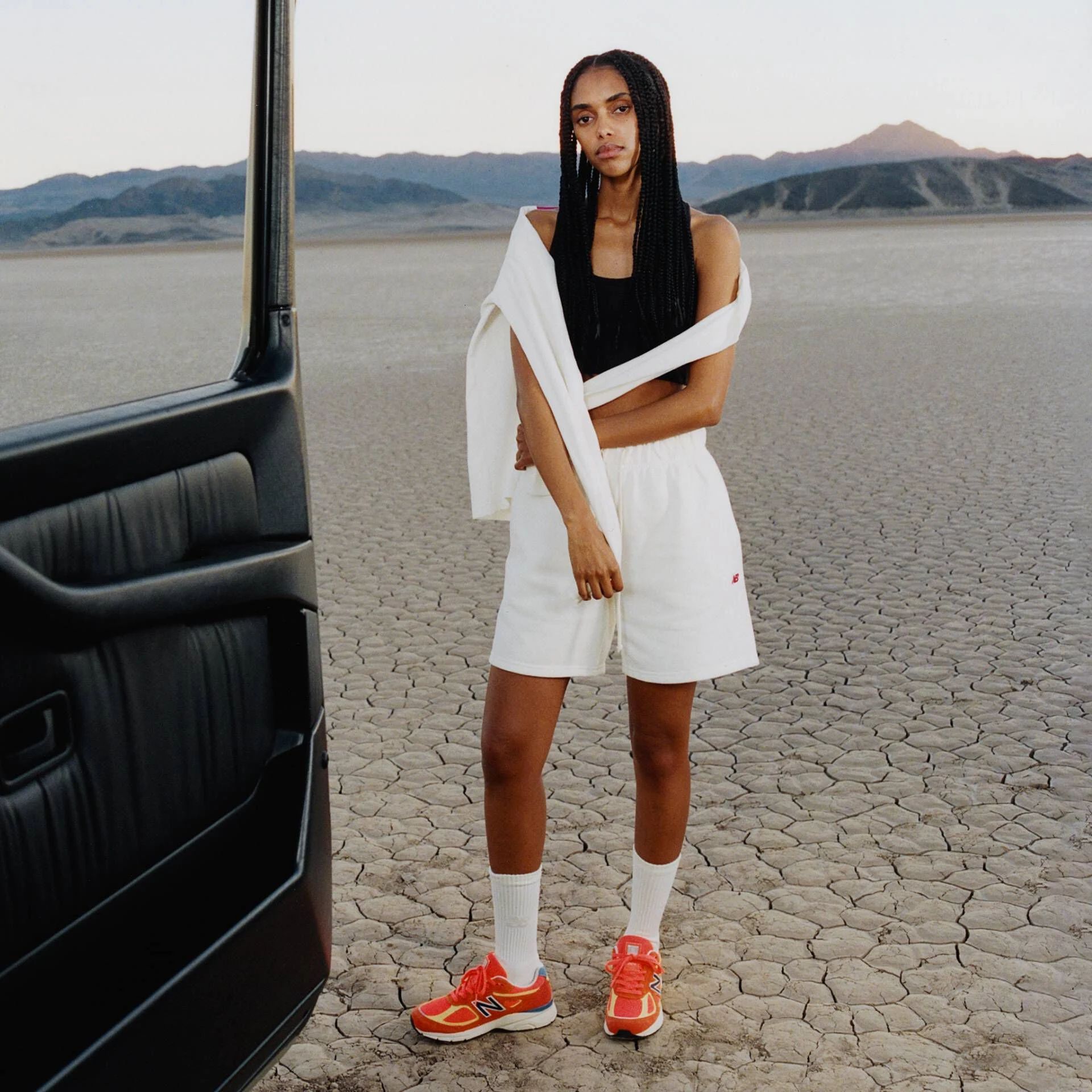A woman standing in a desert environment.