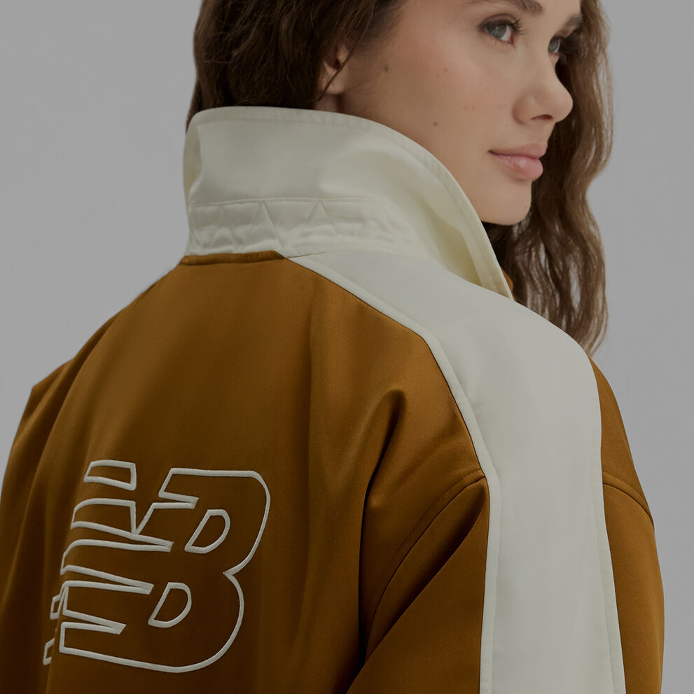 A woman in a brown jacket.