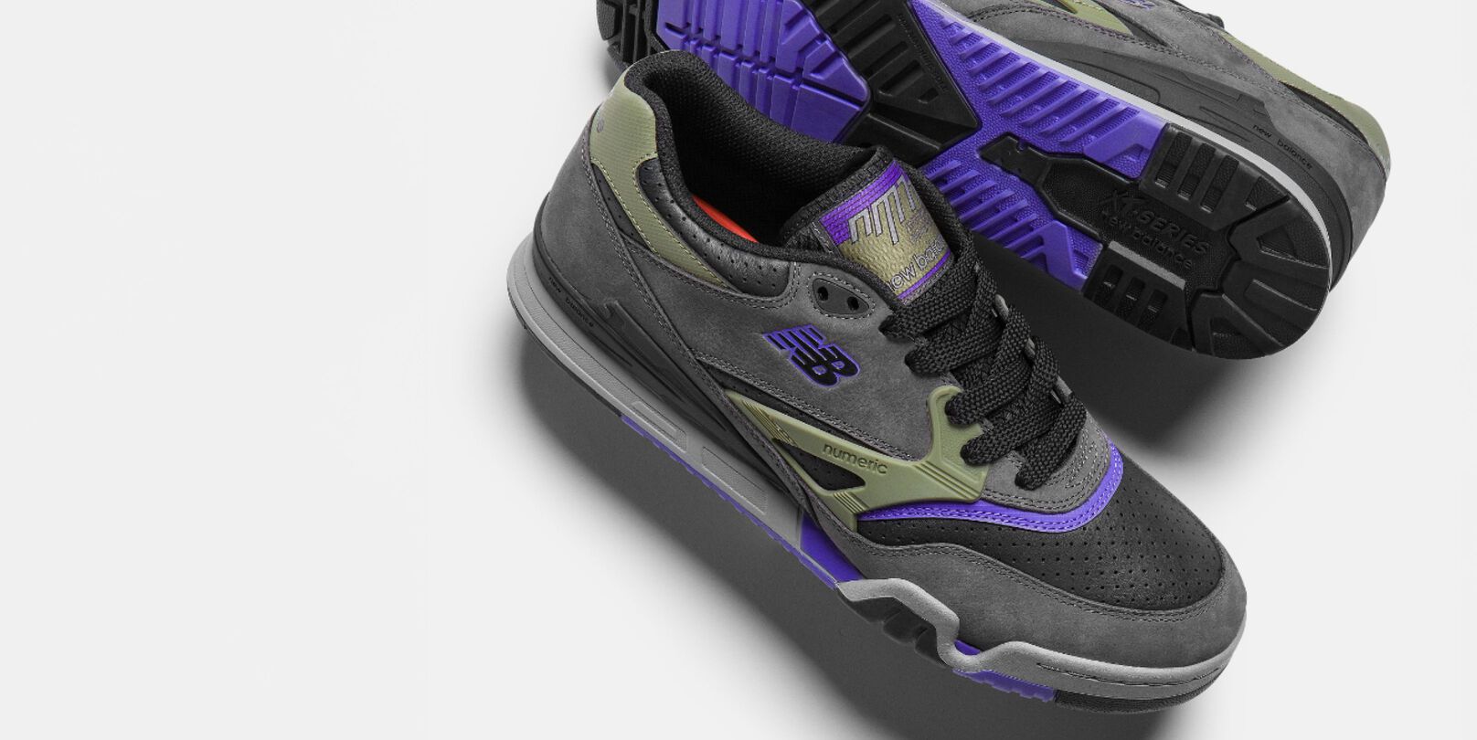 A pair of grey, green, and purple 770 shoes.