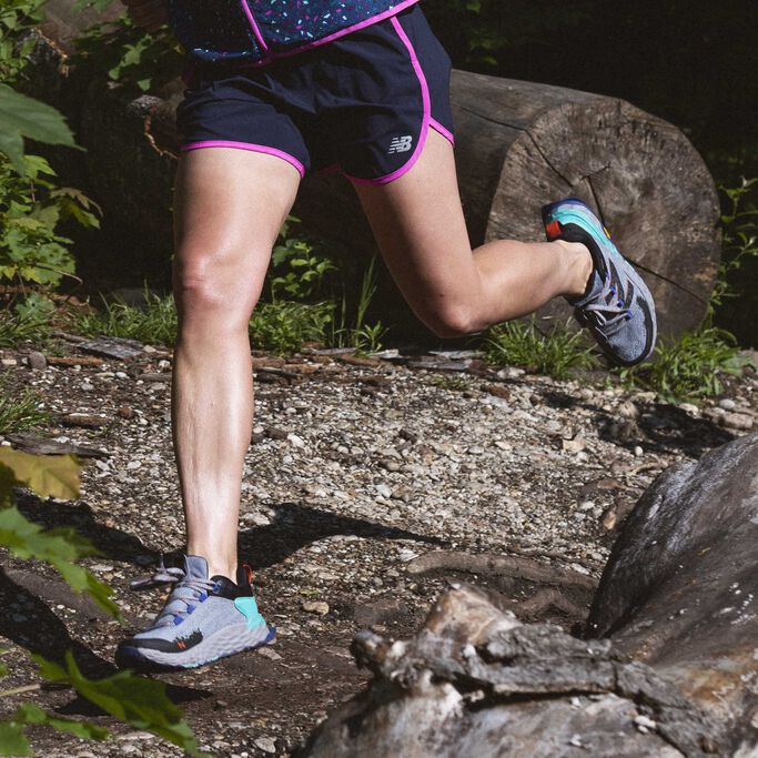 Woman running in Fresh Foam Hierro trail shoes on wooded trail