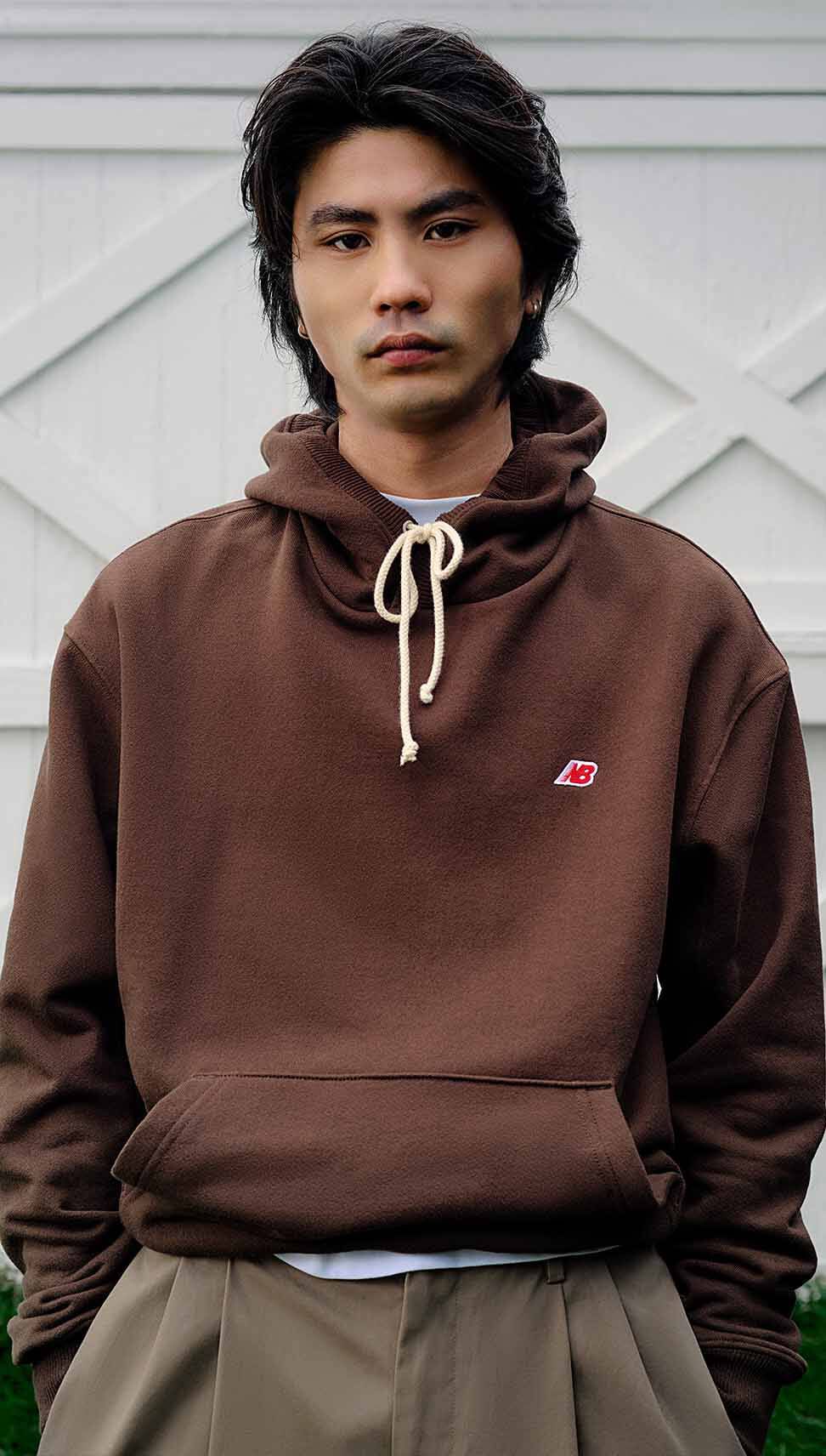 A man wearing a brown hoodie.