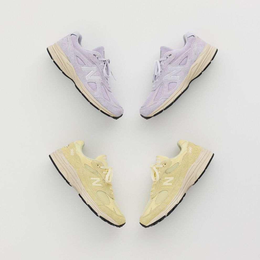 A pair of shoes laying in a grey studio backdrop.