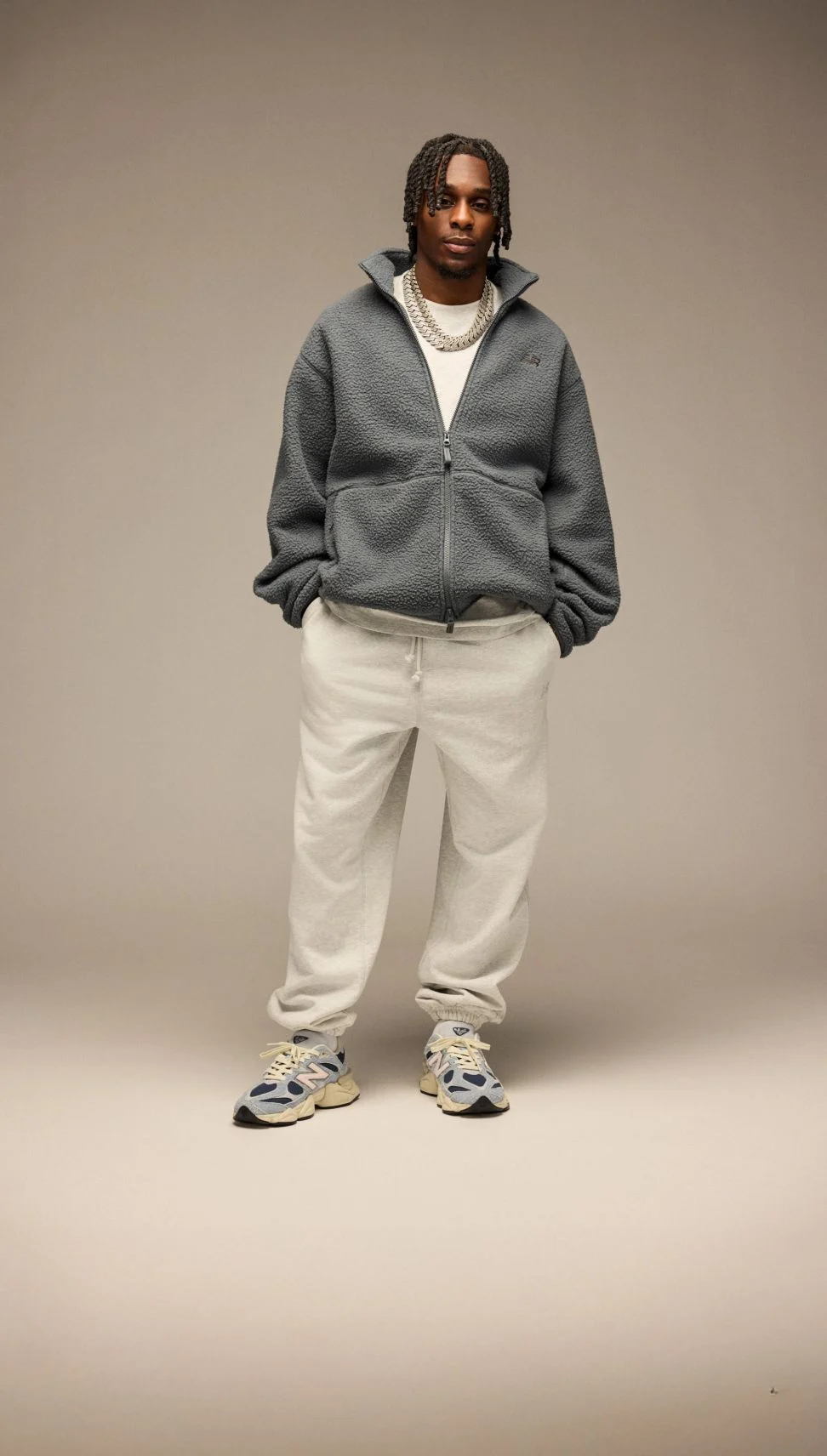 Jeremie Frimpong wearing New Balance Sneakers on a beige background. 