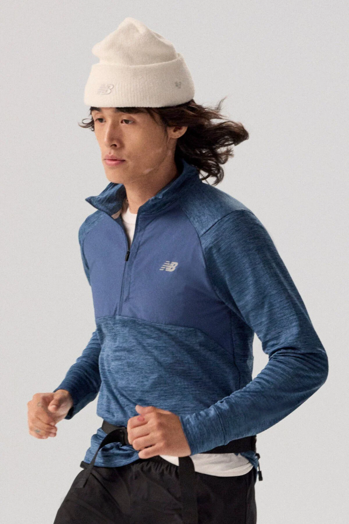 Young man wearing NB clothing and '47 brand hat.