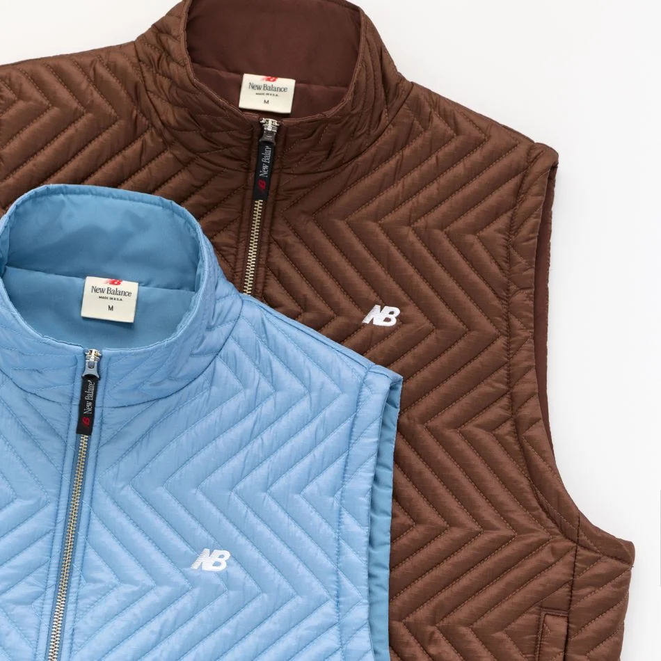 A brown vest and blue vest laying on top of each other.