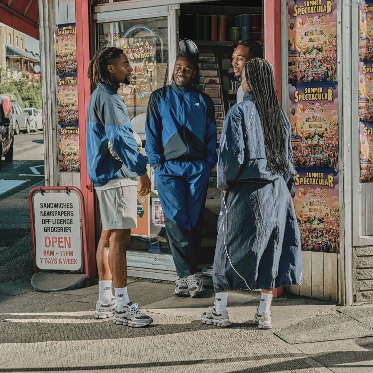 Eze standing outside of a store with his hands in his pockets.