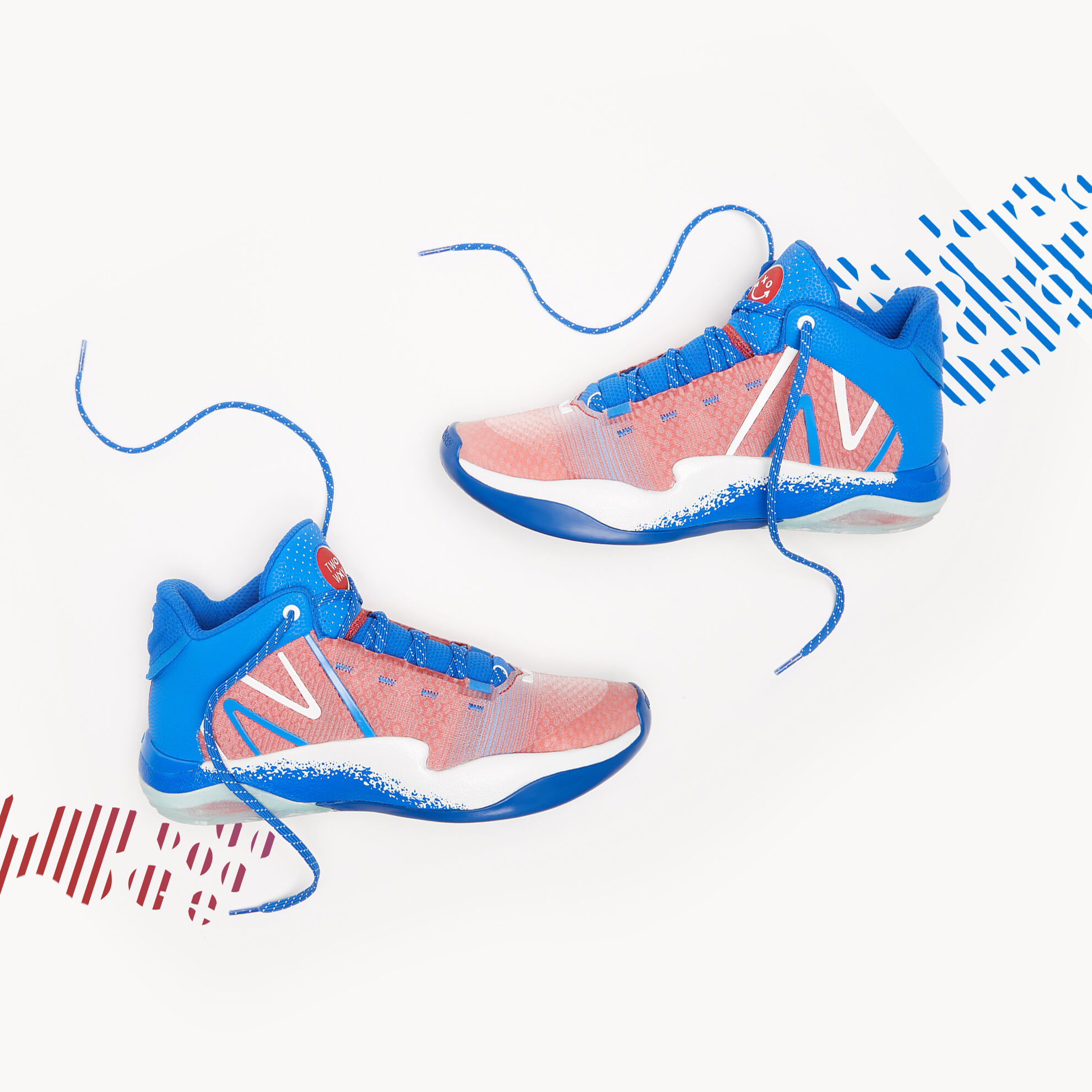 Red, white, and blue basketball shoes sitting on a grey background.