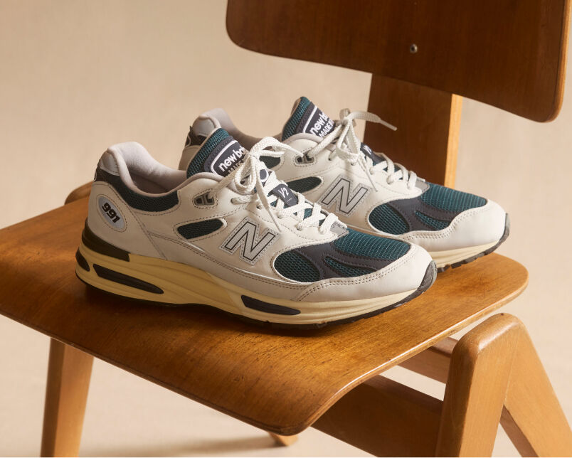 A pair of&nbsp;New Balance Made in UK sneakers in a beige studio environment.