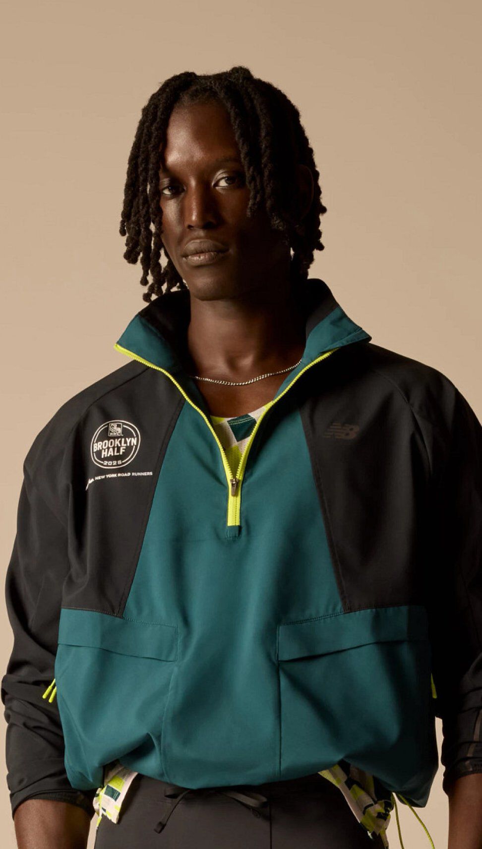 A man wearing United Airlines NYC Half Collection apparel in studio. 