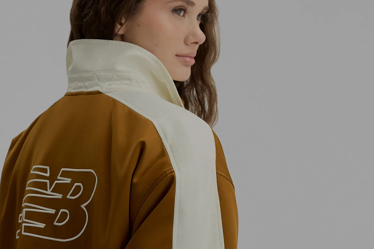 A woman in a brown jacket.