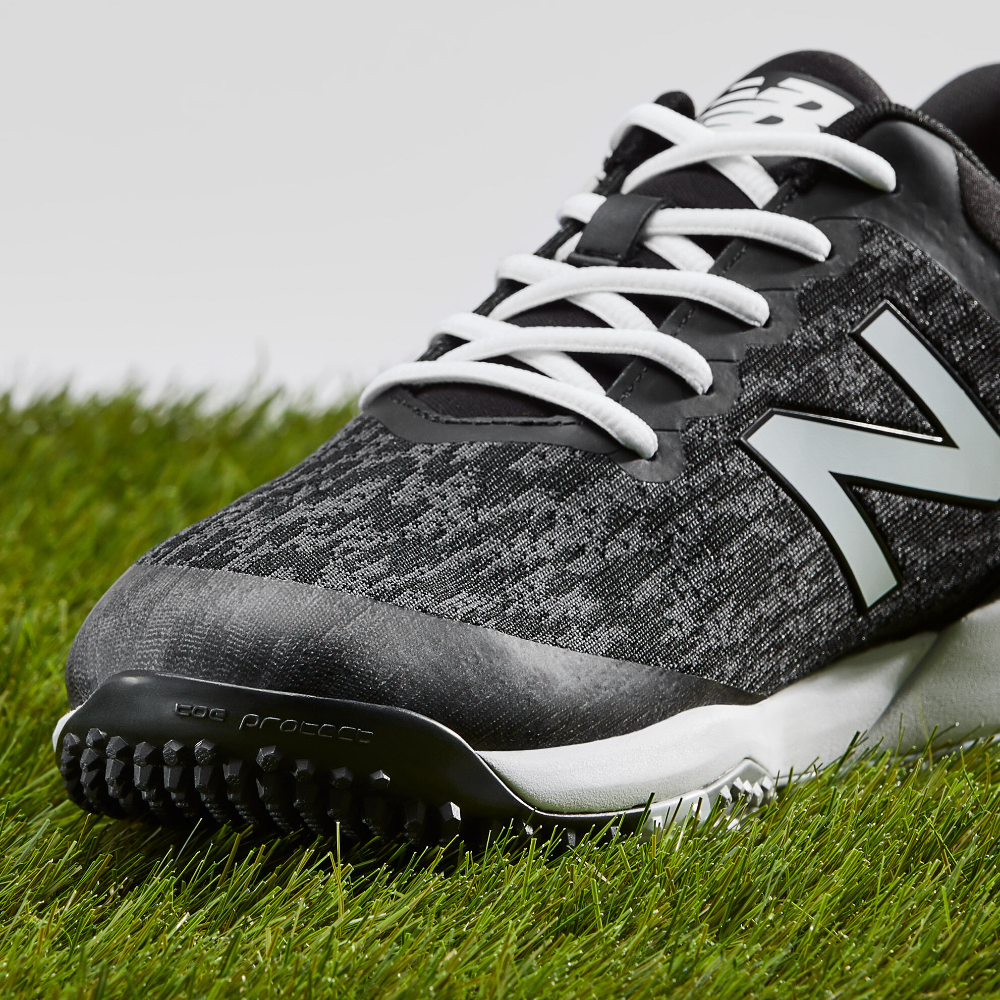 new balance black turf shoes