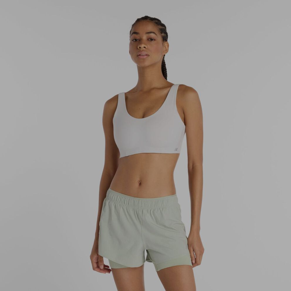 A woman wearing a white New Balance sports bra.
