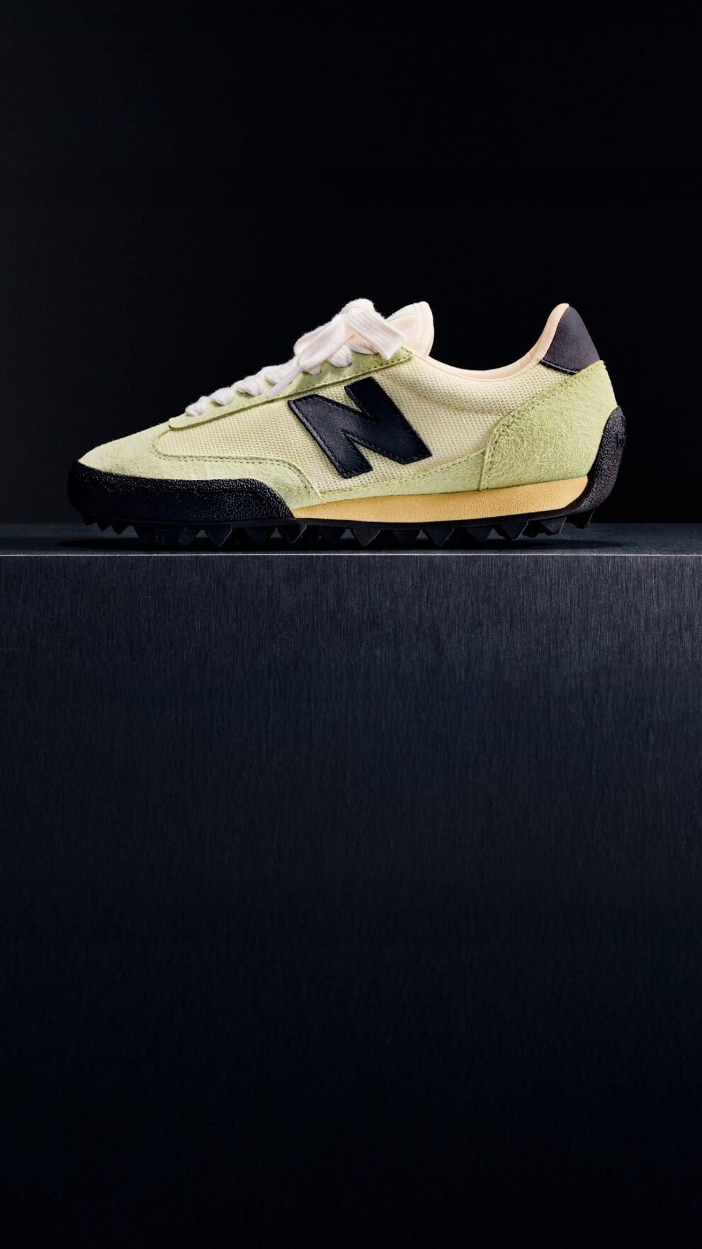  Single green sneaker on a black background 