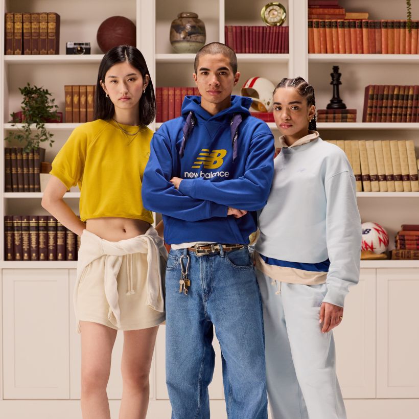Group of students standing in front of a bookshelf. 