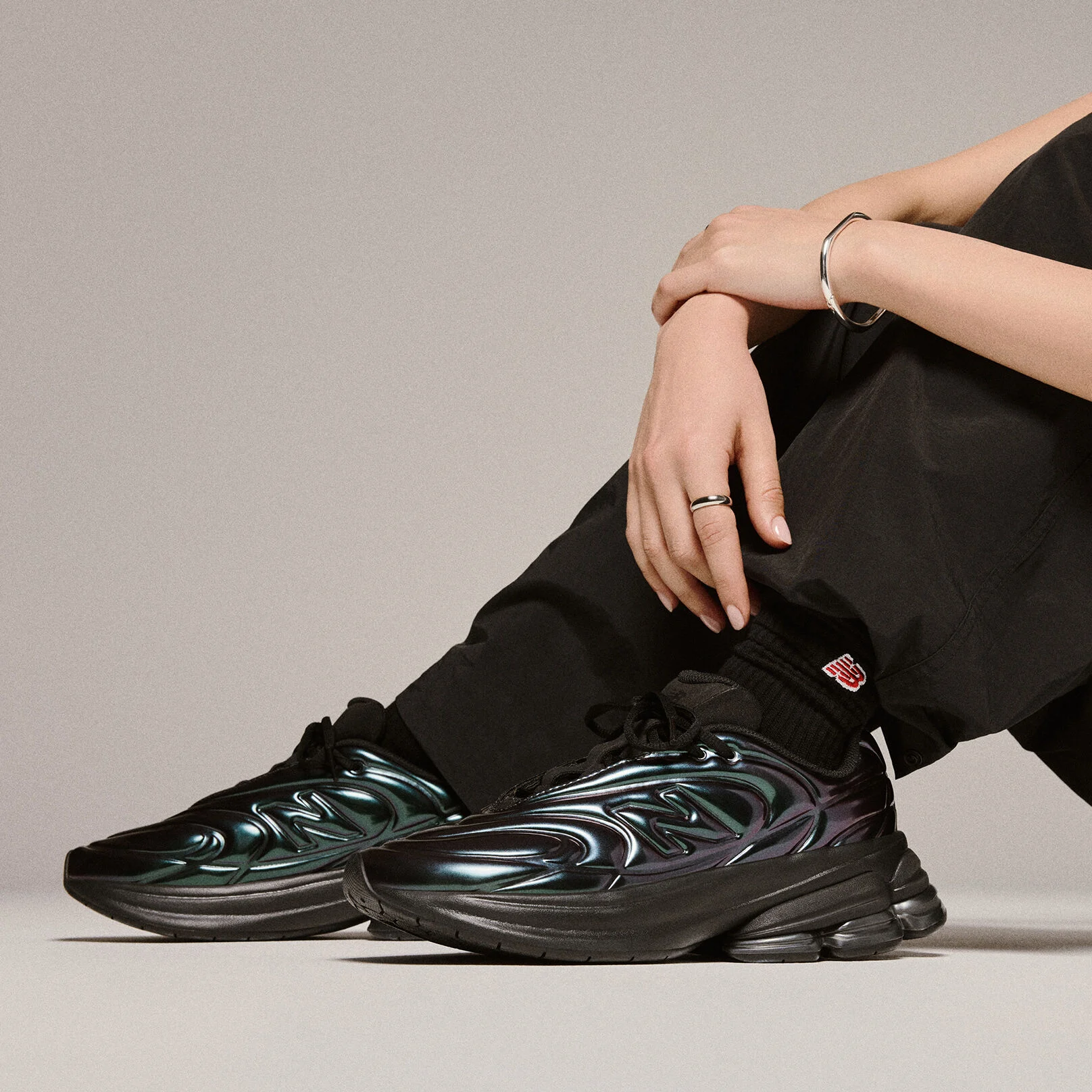 Knee down photo of a person wearing 5030 shoes in a studio