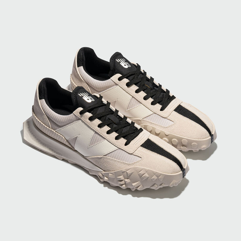 Isometric view of beige XC-72 shoes in grey studio environment