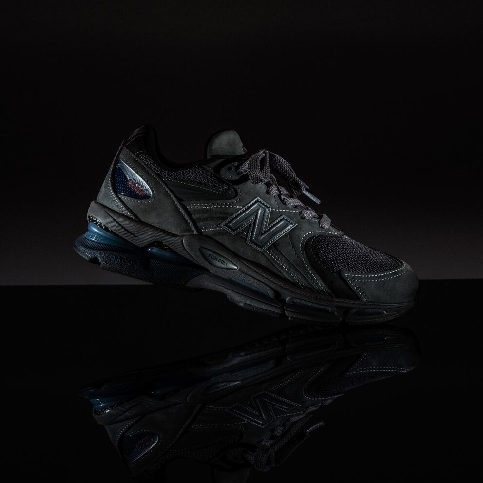 A dark shoe in a black studio environment.  
