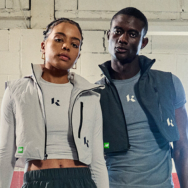 Two people wearing Klutch shirts and vests. 