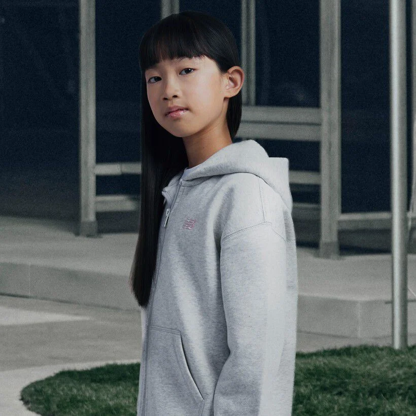 Girl wearing grey New Balance hoodie