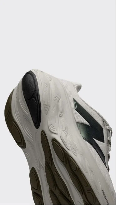 Heel detail of a white and purple Fresh Foam X 1080 shoe.