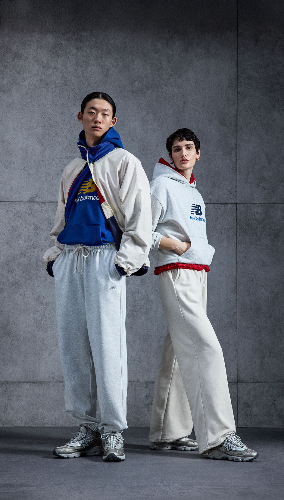 Two individuals wearing New Balance 1000 shoes in a studio background