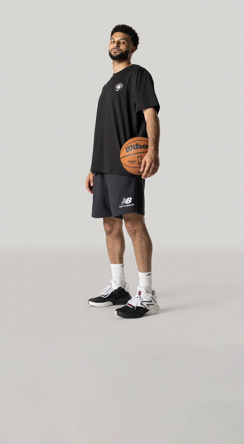 Jamal Murray posed with basketball against a grey studio backdrop wearing black New Balance t-shirt and shorts with the TWO WXY v4 ‘Dualism’ shoes 