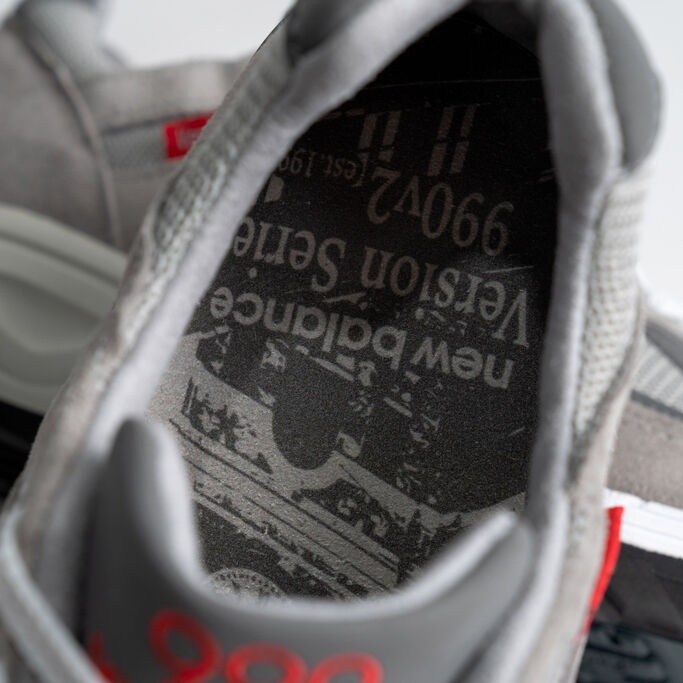 Top down shot of the 990v2’s insole graphic featuring the Lawrence, MA factory clock tower.