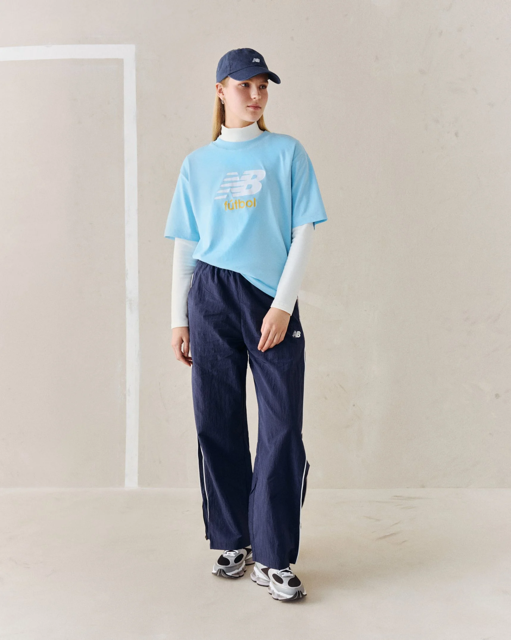 A person wearing a blue soccer graphic tee.