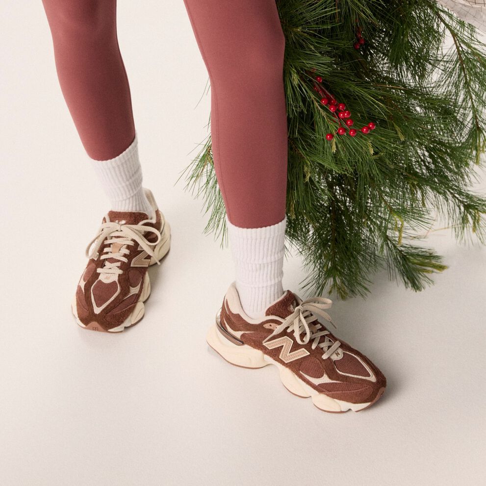 Young woman in maroon tights holding a bag of garland.