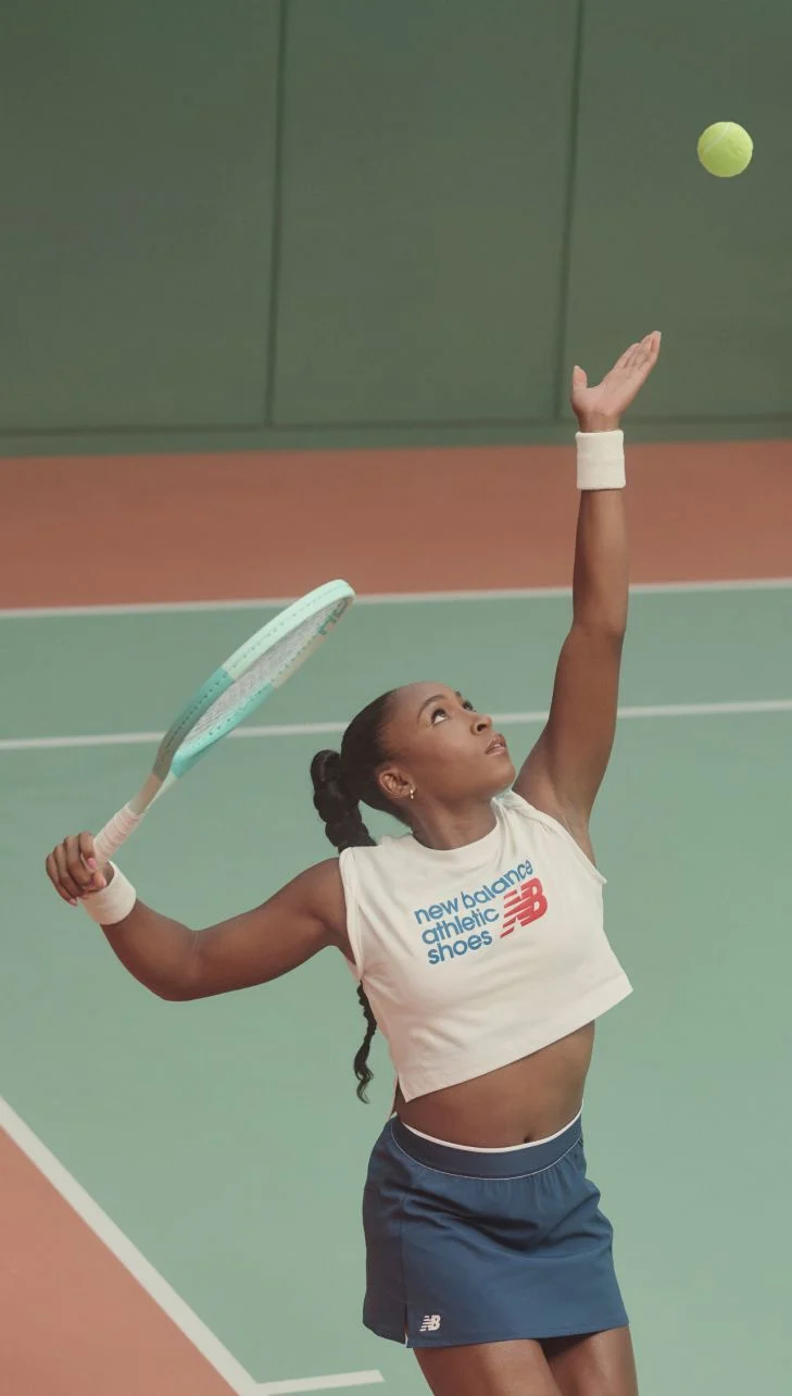 Coco Gauff throwing a tennis ball into the air