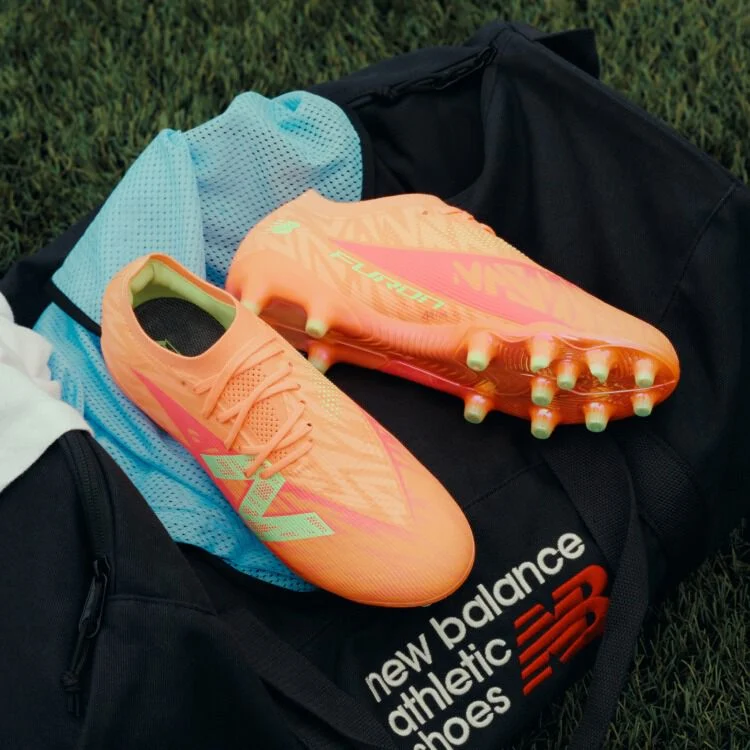 Furon cleats placed on top of a New Balance duffle bag.
