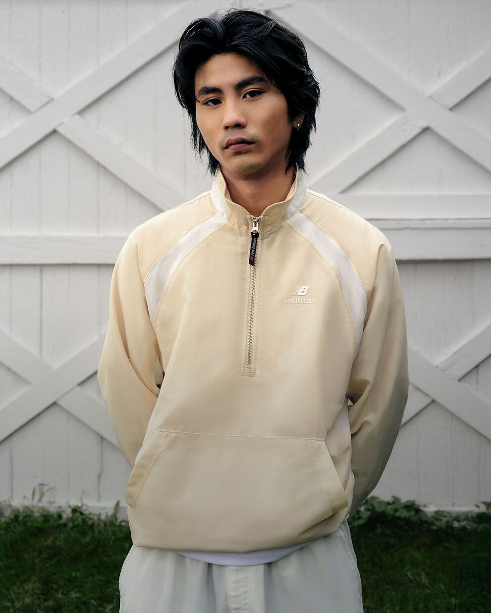 A man standing in front of white barn doors.