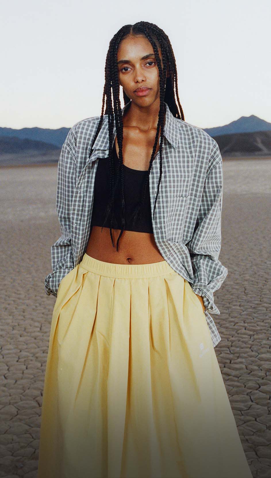 A woman standing in a desert environment.
