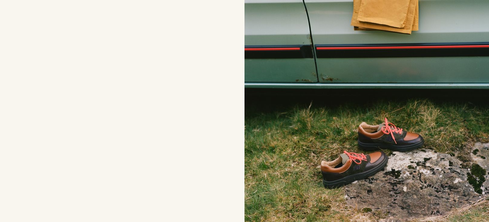 A pair of Drakes’s x New Balance shoes on the grass next to a vintage car.