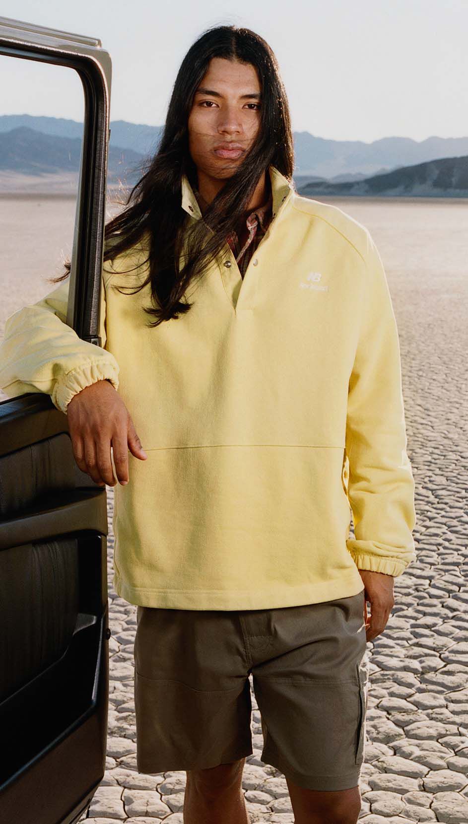 A man standing in a desert environment. 