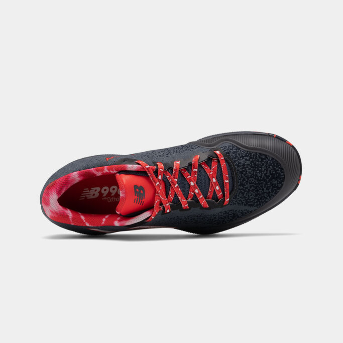 A top down view of a dark blue tennis shoe on a grey background.