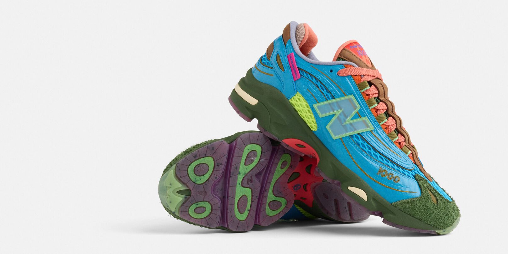 A pair of colorful New Balance x Salehe 1000 shoes on a grey background. 