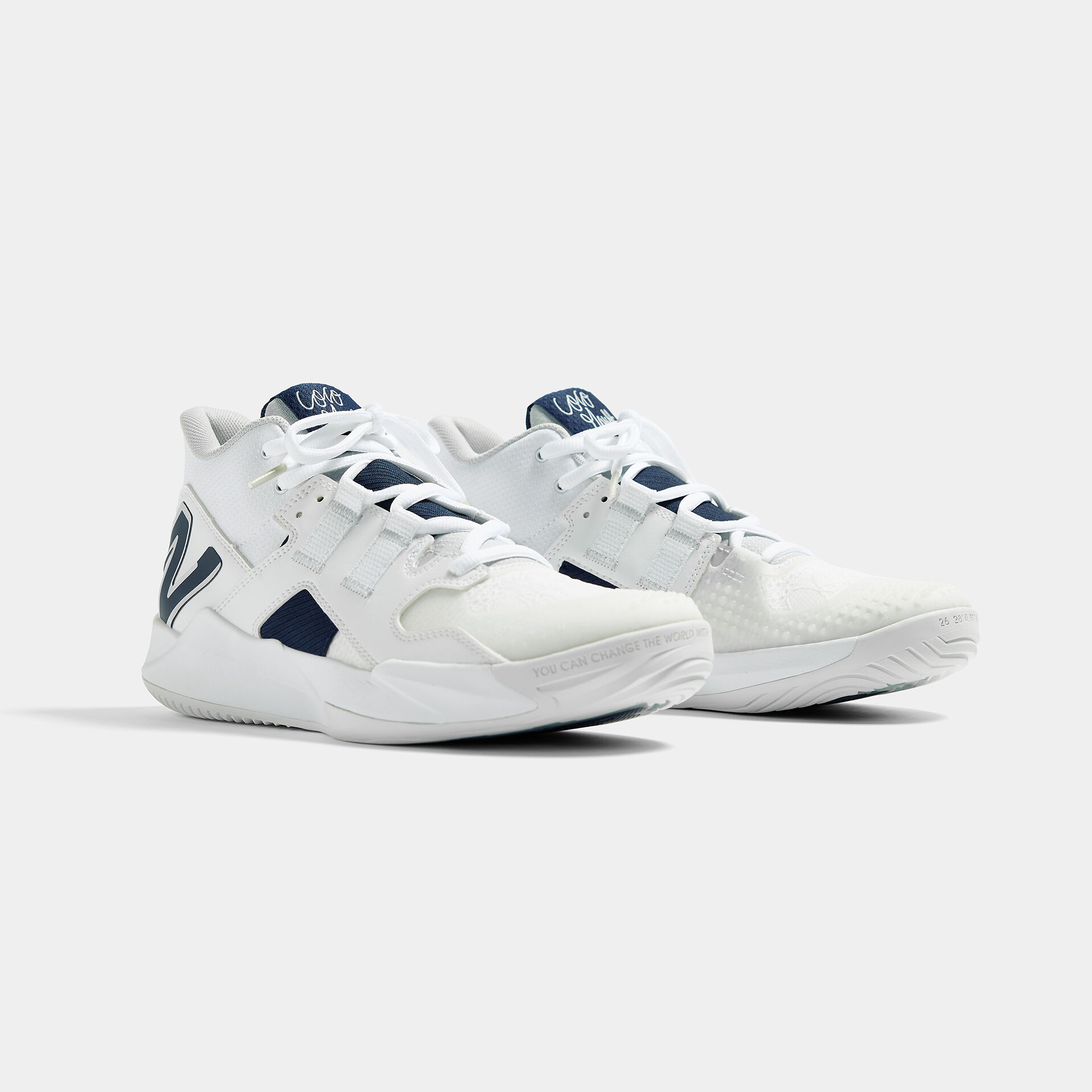 Pair of shoes sitting next to each other on a grey background.
