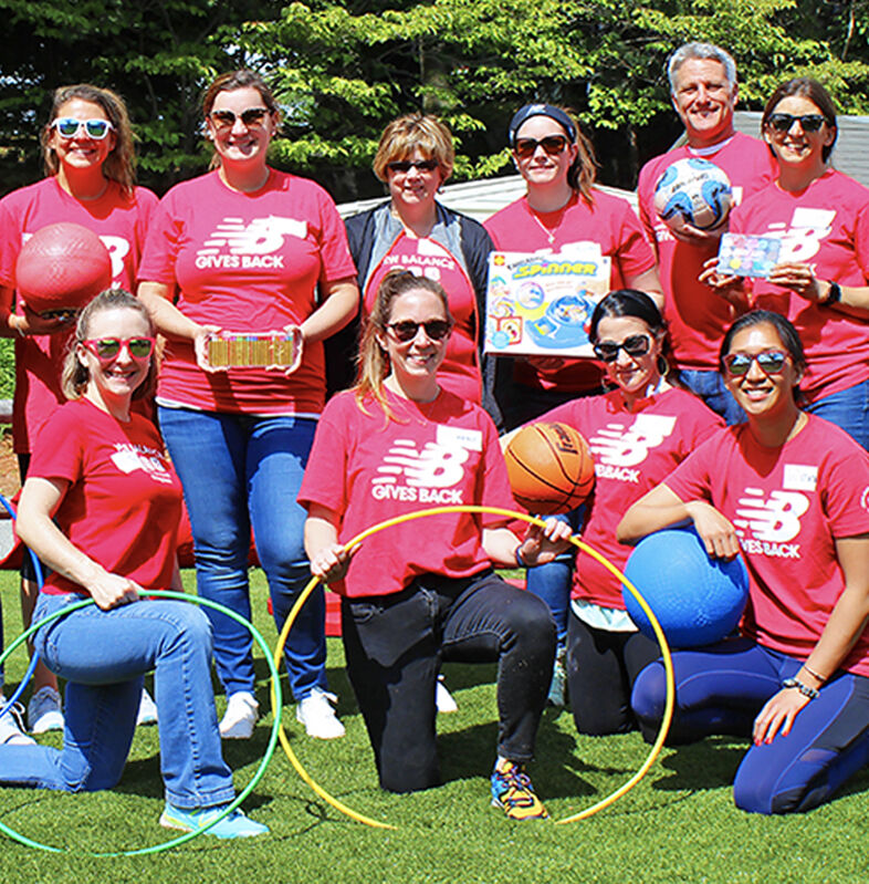 Employees participating in field day with kids