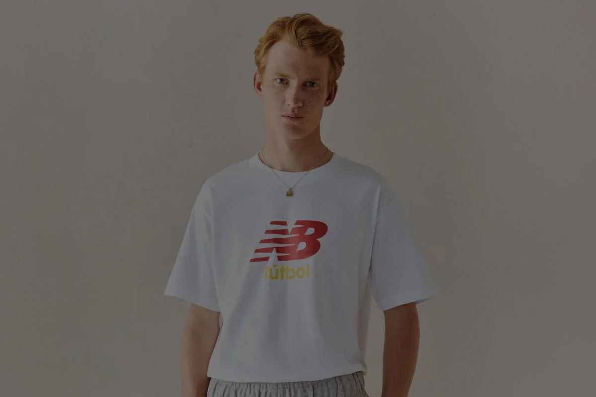 A man wearing a New Balance graphic tee.