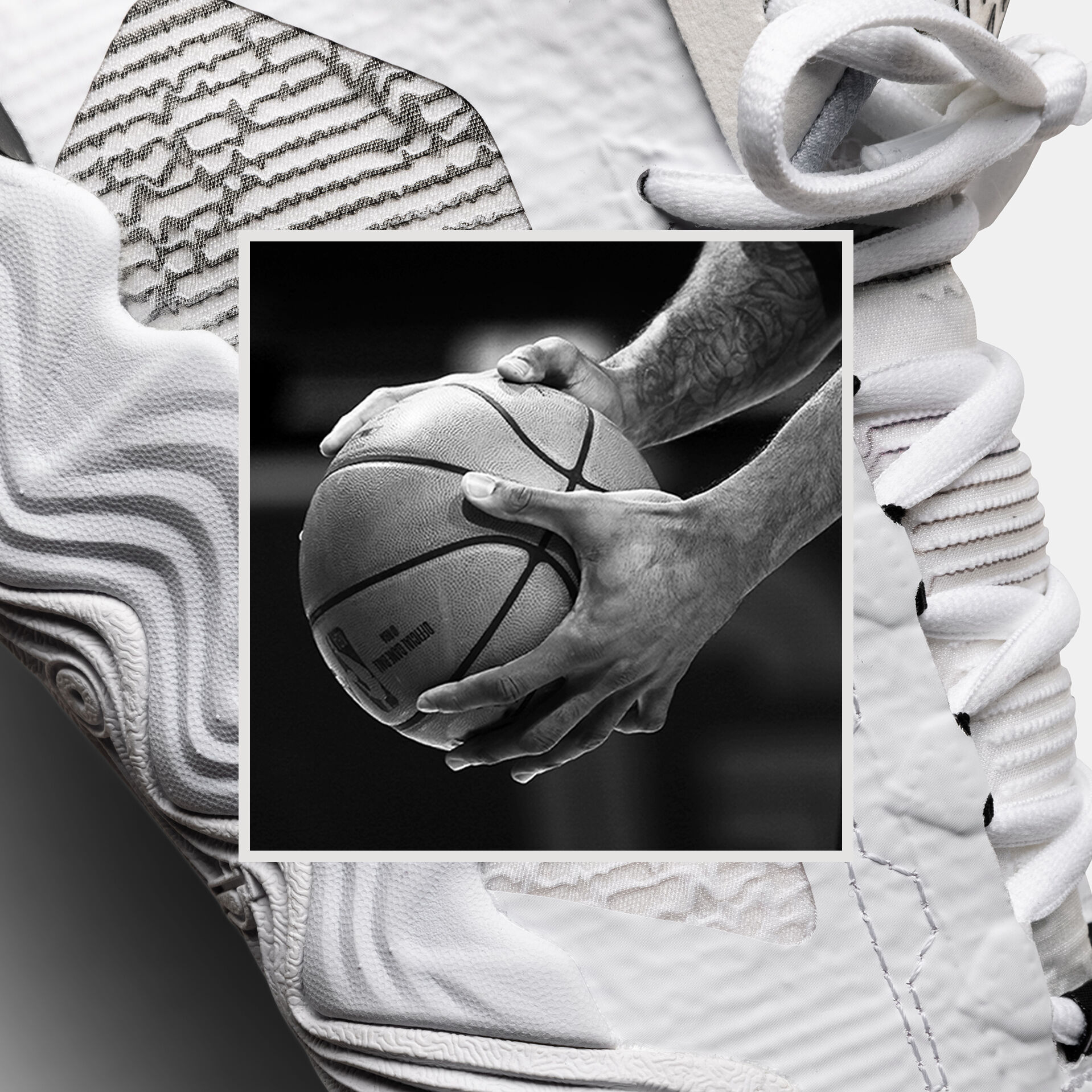 Hands holding a basketball over a detail shot of a white basketball shoe.