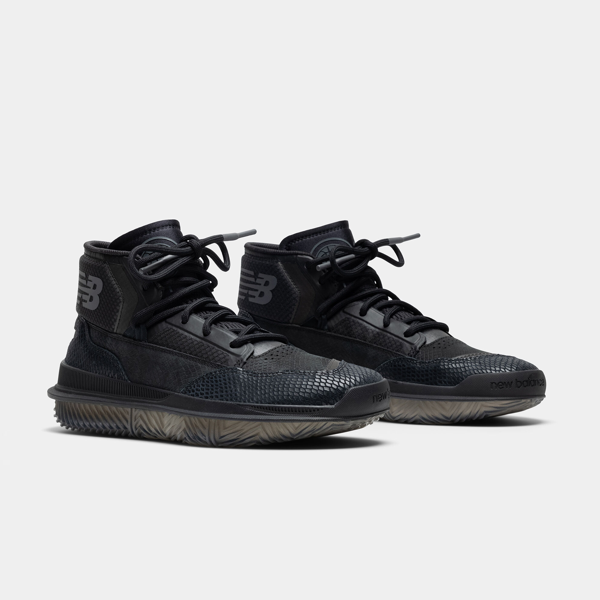 Pair of black BB9000 basketball shoes on grey studio background