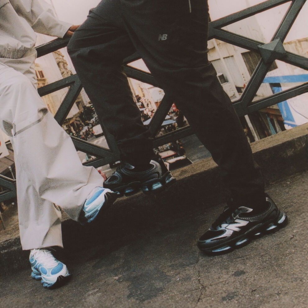 Knee down image of two people wearing ABZORB 2000 sneakers  
