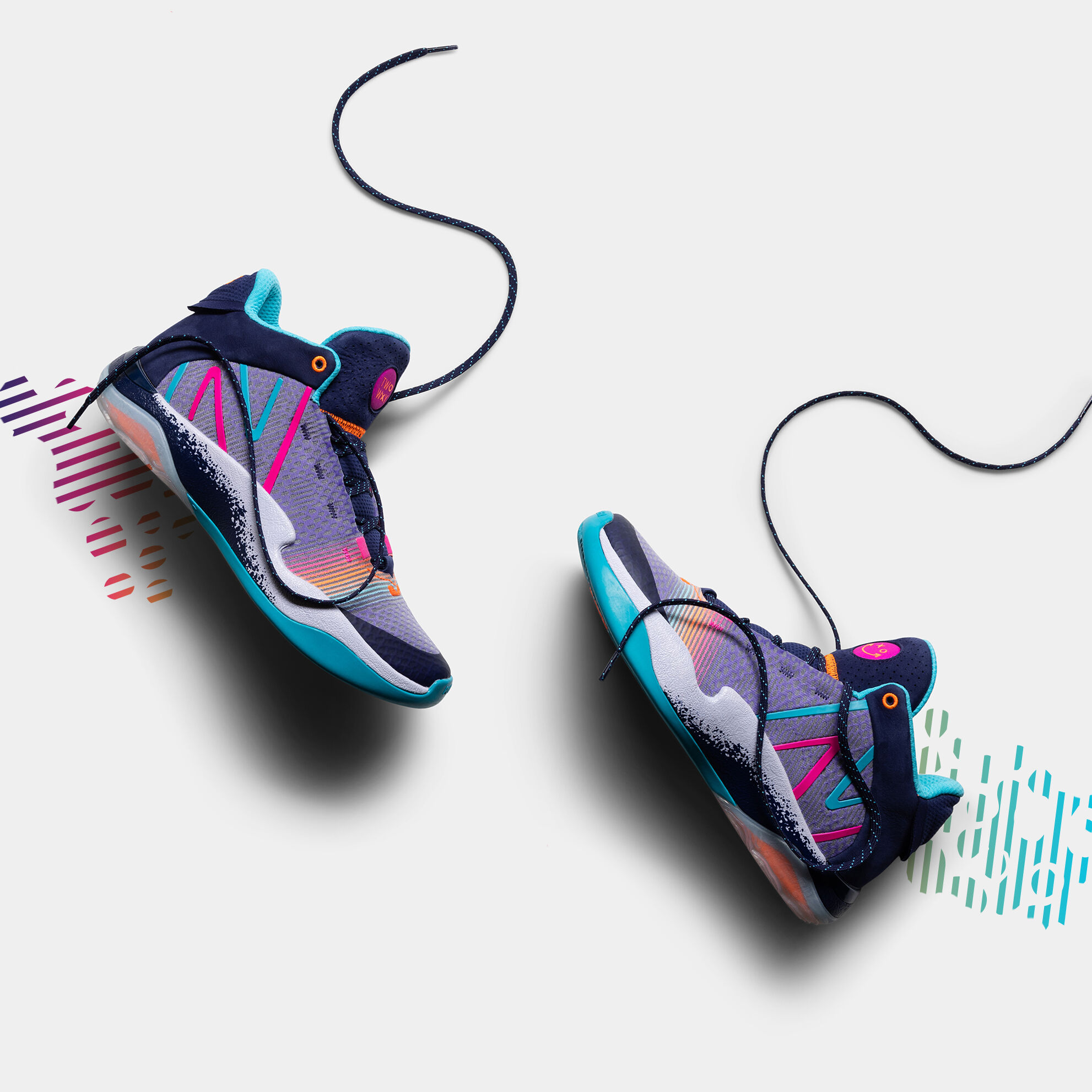 Pair of shoes laying on a light grey background with the laces out.