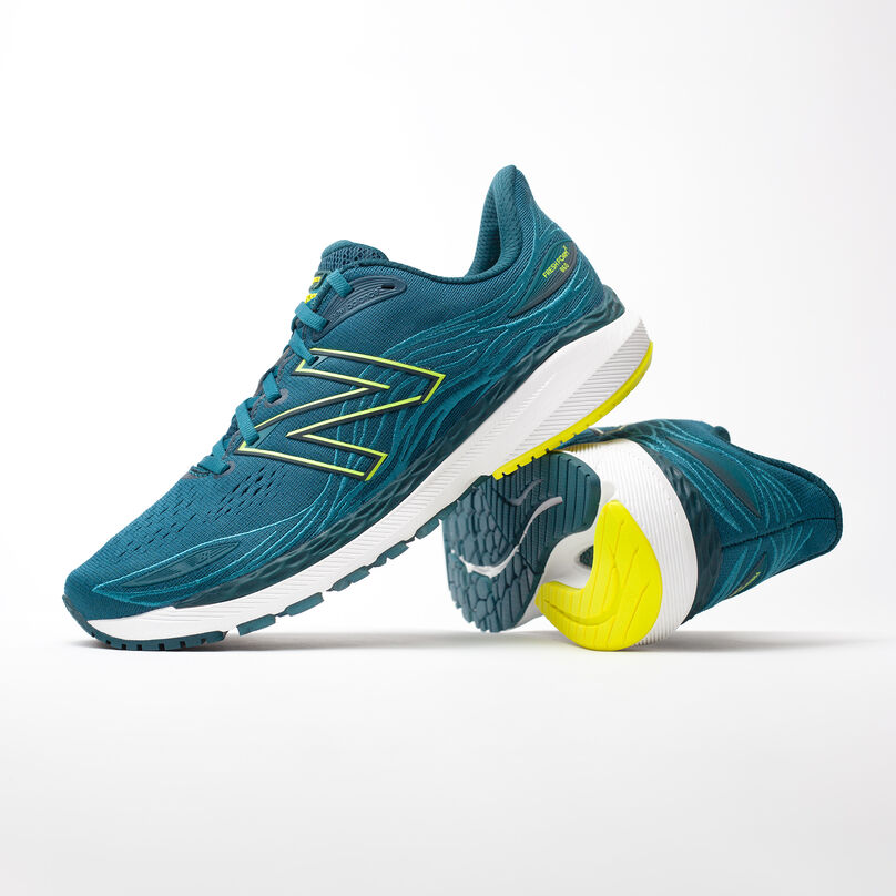 Left pair, side profile of dark green Fresh Foam X 860v12, resting on the heel of the right pair with heel facing front