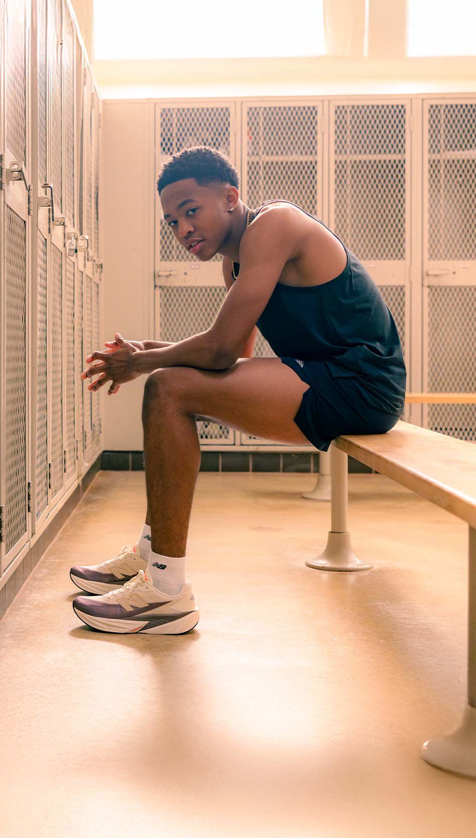 Quincy Wilson sitting on a bench in a locker room