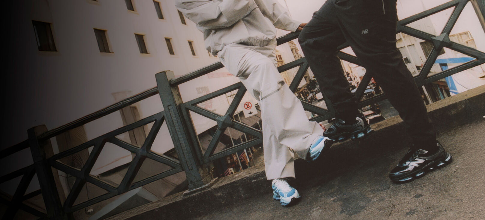 Knee down image of two people wearing ABZORB 2000 sneakers  